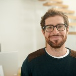 portrait of smiling man wearing glasses